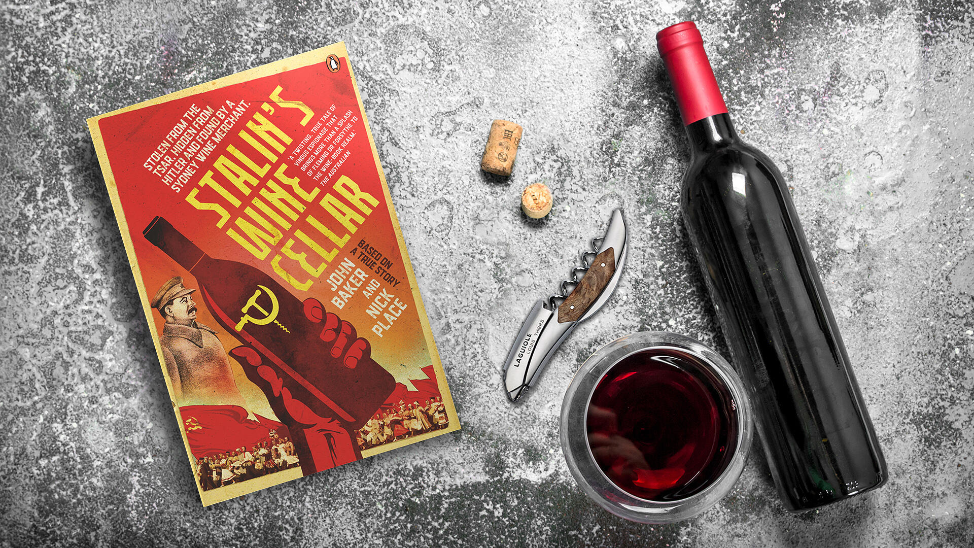 Photo of Stalin's Wine Cellar Book, Laguiole corkscrew, wine glass, corks and wine bottle.